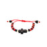 This genuine Azabache bracelet for baby combines spiritual protection with style, showcasing a central black cross design. It is crafted with an adjustable red rope featuring black bead ends and alternating red and black beads that create an eye-catching pattern.